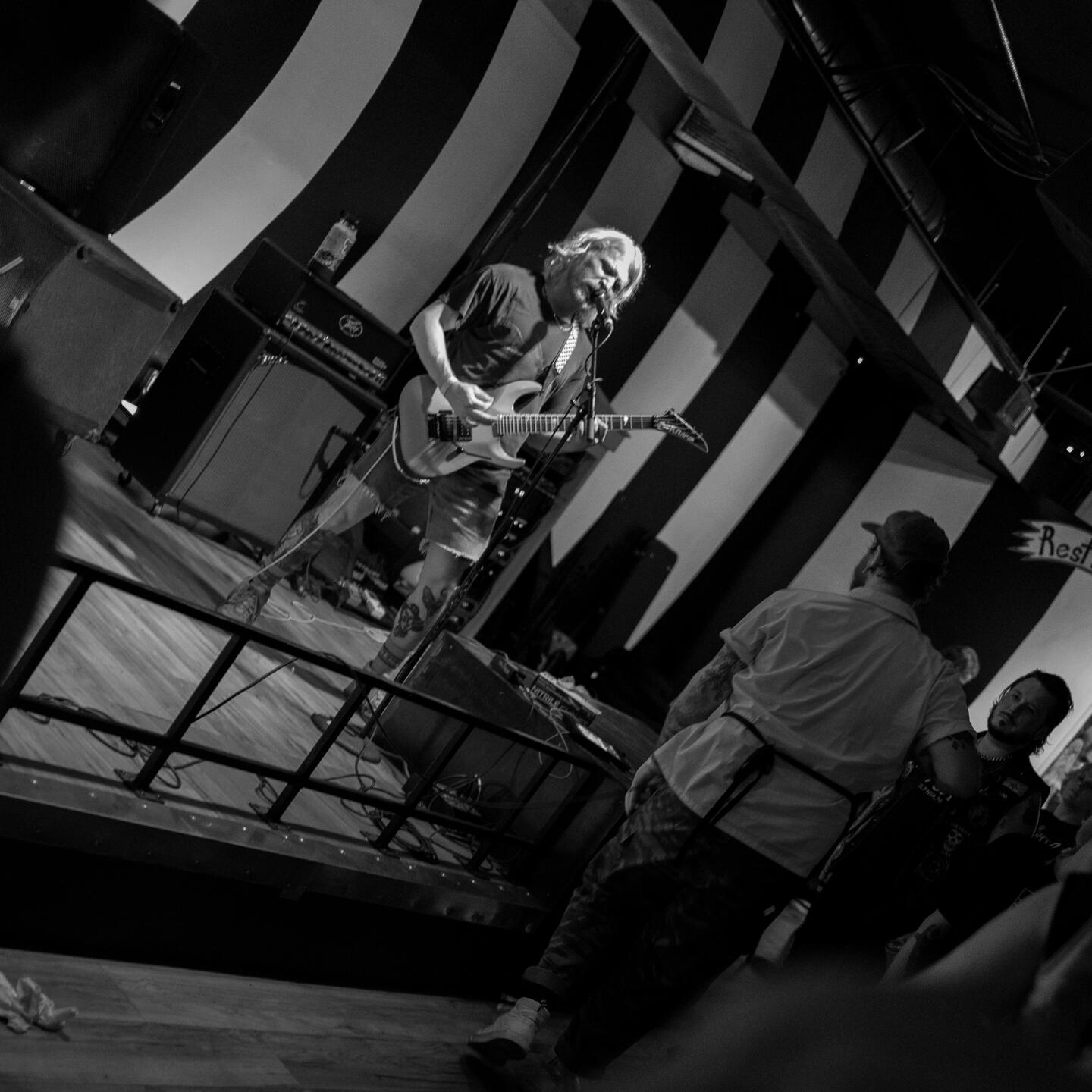 Benchscraper's lead guitarist shredding on stage.